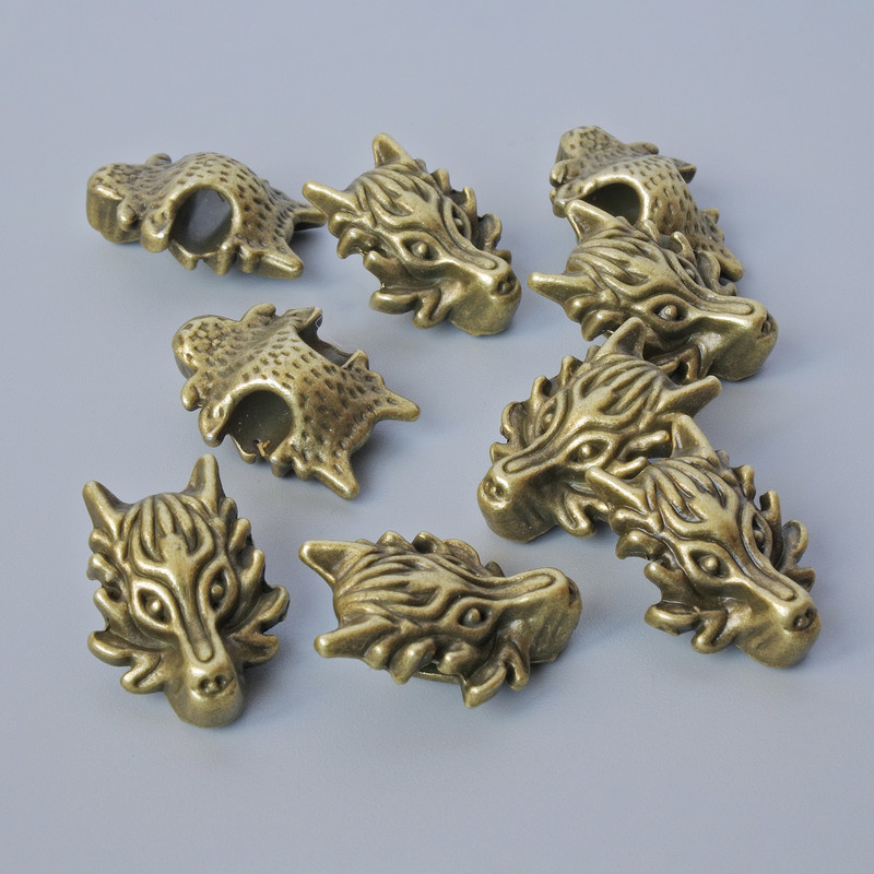 Kovová korálka-vložka „Drak“, průměr 18×13×8 mm, průměr dírky 3,7 mm, balení 9 ks ±, bronzová barva kovu