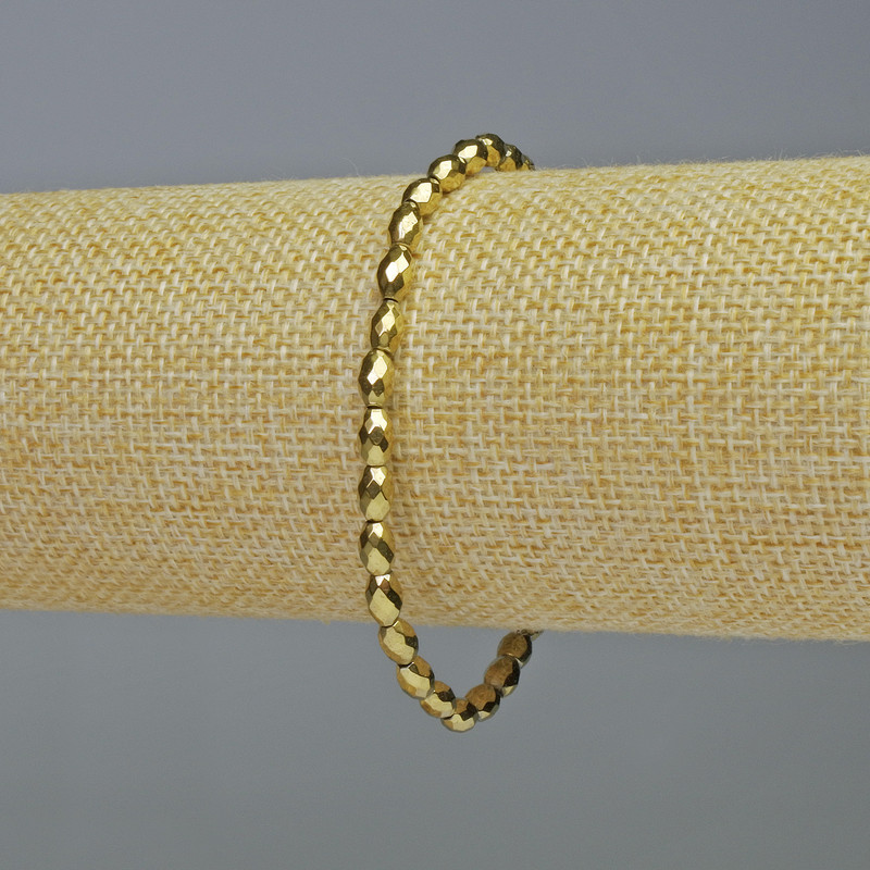 Náramek z hematitu – broušené oválné korálky zlaté barvy, průměr 4×6 mm ±, délka 18 cm ±, elastický