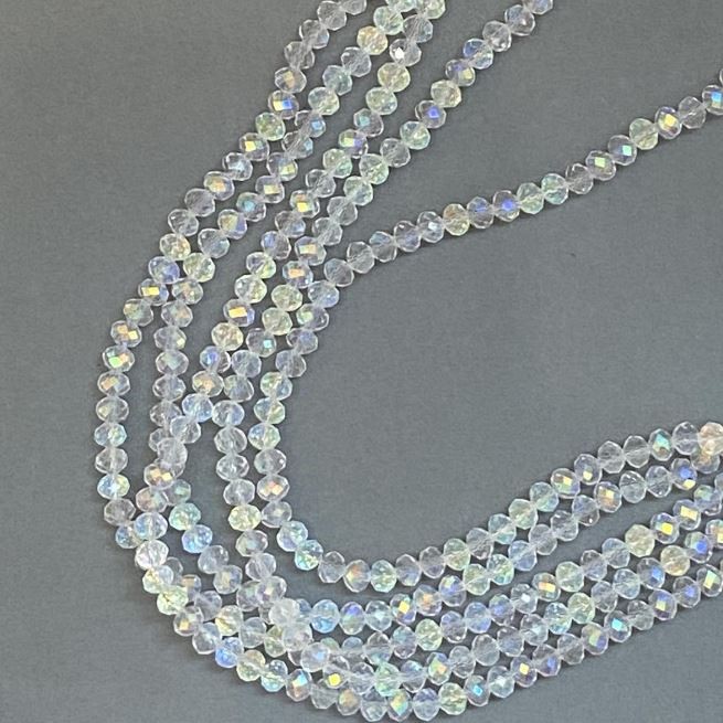 Korálky Český křišťál na niti bílé průhledné s benzínovým nástřikem, brusované rondely, průměr 6×5 mm, délka 39 cm