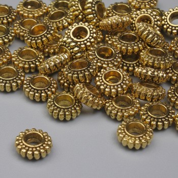 Kovová součástka – korálka vložka, barva kovu zlato, průměr 7×3 mm, díra cca 2,8 mm, balení 20 g (~41 ks)