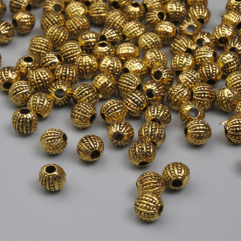 Korálková vložka zlaté barvy, průměr 4 mm, otvor 1 mm, balení 20 g (~125 ks)