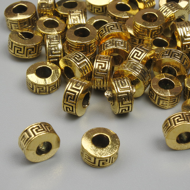Korálkové vložky zlaté barvy, průměr 6,5×4 mm, díra 2,8 mm, balení 20 g (~37 ks)