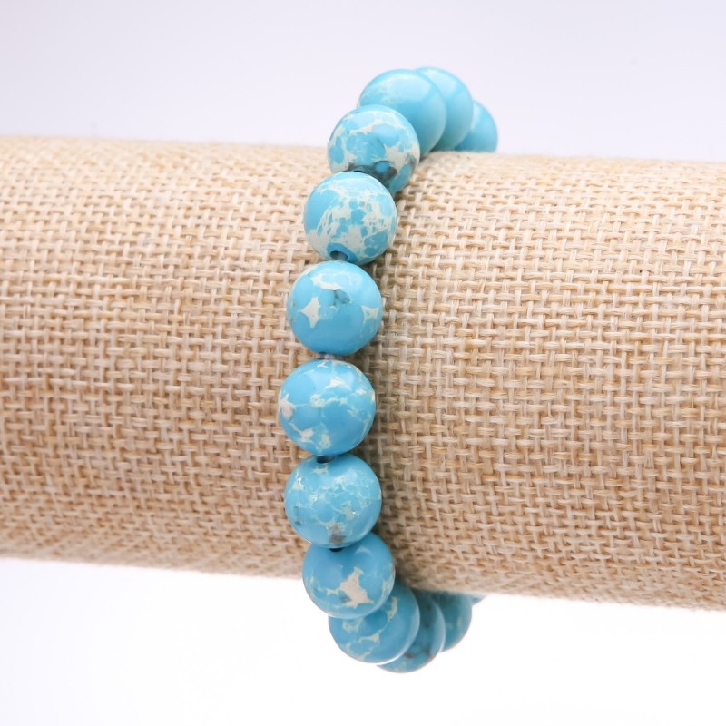 Náramek z variscitu (lisovaný) světle modrá hladká kulička, průměr 10 mm, délka 18 cm na elastické gumičce