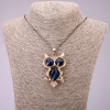 Přívěšek „Sova“ se modrými krystaly na dlouhém řetízku z kovu „černé zlato“, průměr 41×62 mm, délka 70 cm