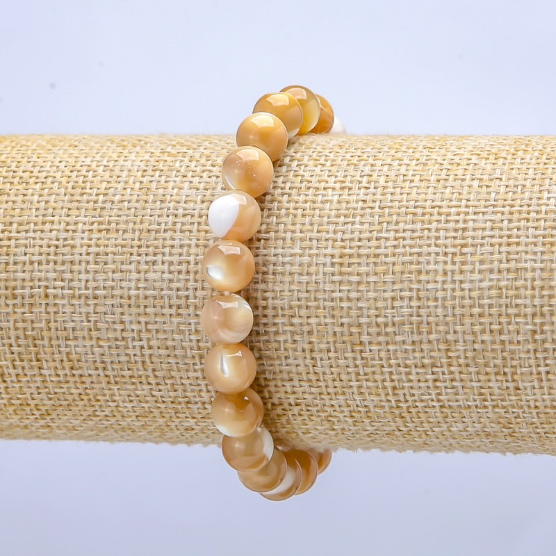 Náramek na elastické šňůře z přírodní perleti béžový, hladká korálka, průměr 6 mm, délka 18 cm