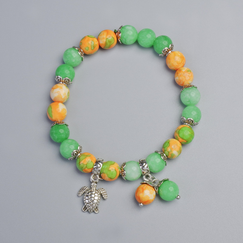 Náramek z variscitu (syntetický akryl) a nefritu (syntetický), průměr 8,5 mm ± (elastická šňůra), délka 18 cm ± s kovovými vložkami