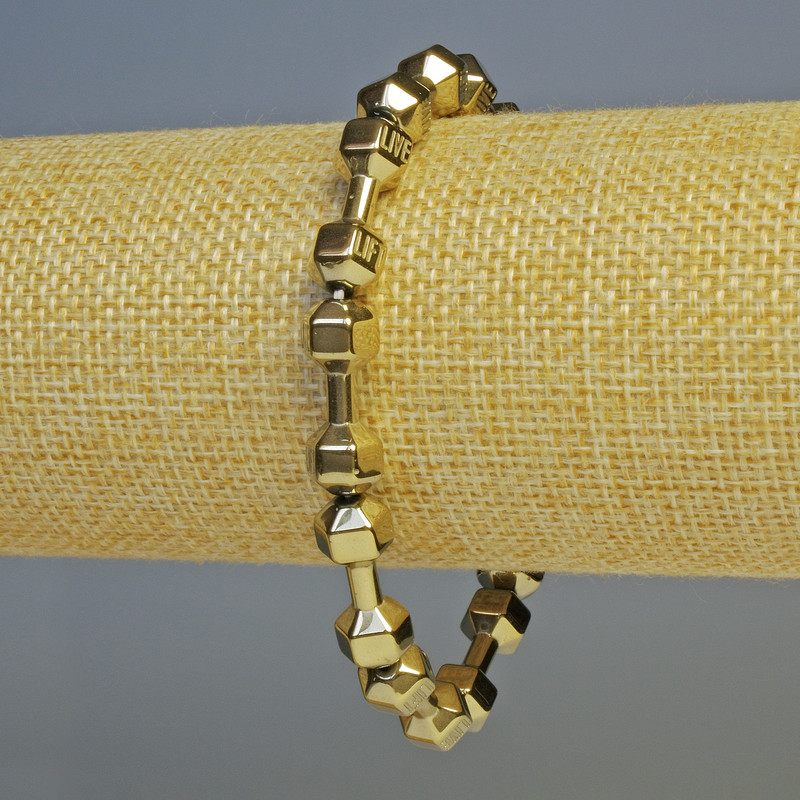 Náramek z hematitu ve tvaru činky, světle bronzová barva, průměr 21×7 mm, délka cca 18 cm, elastický