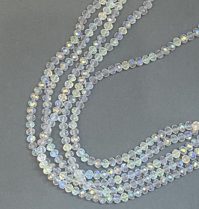 Korálky Český křišťál na niti bílé průhledné s benzínovým nástřikem, brusované rondely, průměr 6×5 mm, délka 39 cm