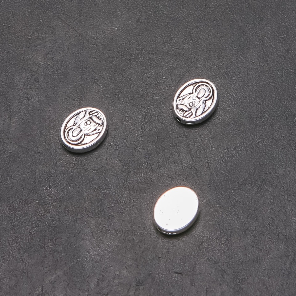 Kovová vložka Obraz, průměr 10×8 mm, otvor 1 mm, balení 20 g, 22 ks. (+ -)