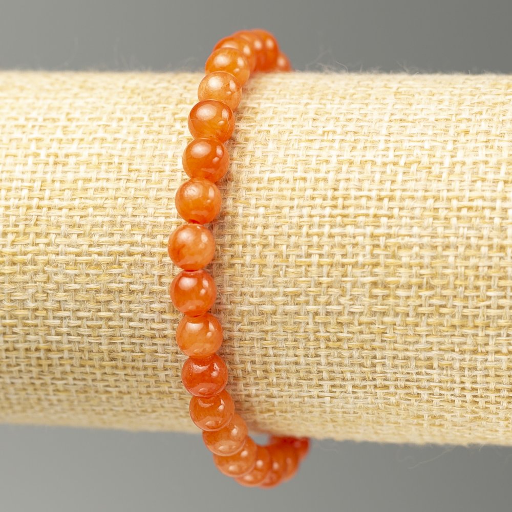 Náramek na gumičce z akrylových kuliček imitujících citrín, hladké kuličky Ø 6 mm, délka 18 cm