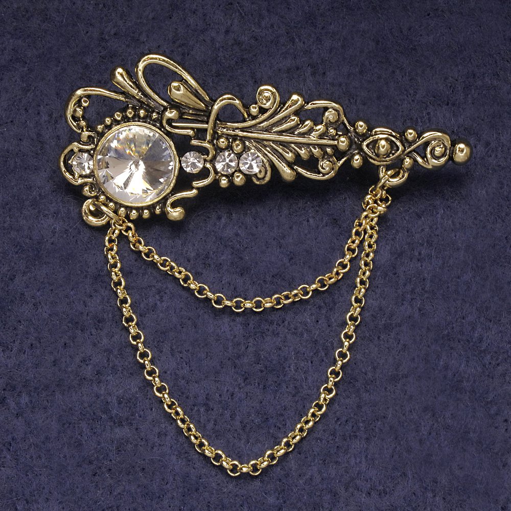 Brož Akcent s bílými kamínky a krystalem, zlatavý kov 55×22 mm